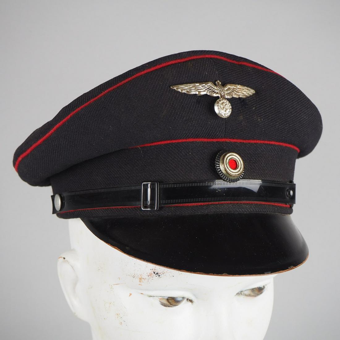 Fire police peaked cap 3rd Reich: Fire police peaked cap 3rd ReichCap for teams. Dark blue cloth with red piping, plastic cord, metal imperial eagle and cockade at the top. Interior hardened leather sweatband. Good condition, eagle pr