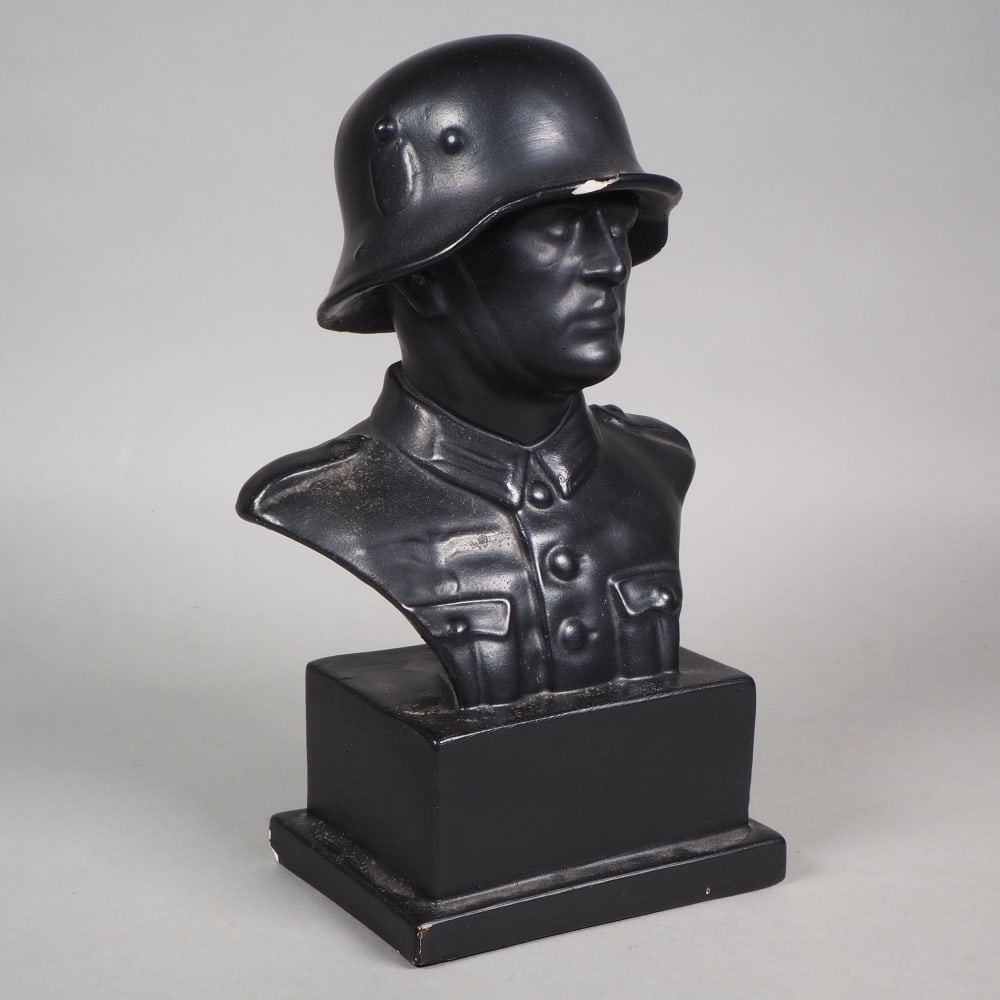 Soldier table bust made of blackened plaster: Soldier table bust made of blackened plasterTable bust made of plaster, painted black, depicting Wehrmacht soldier with M16 steel helmet. Age not verified. H. 27cm. Smaller scattered chips present.Sol