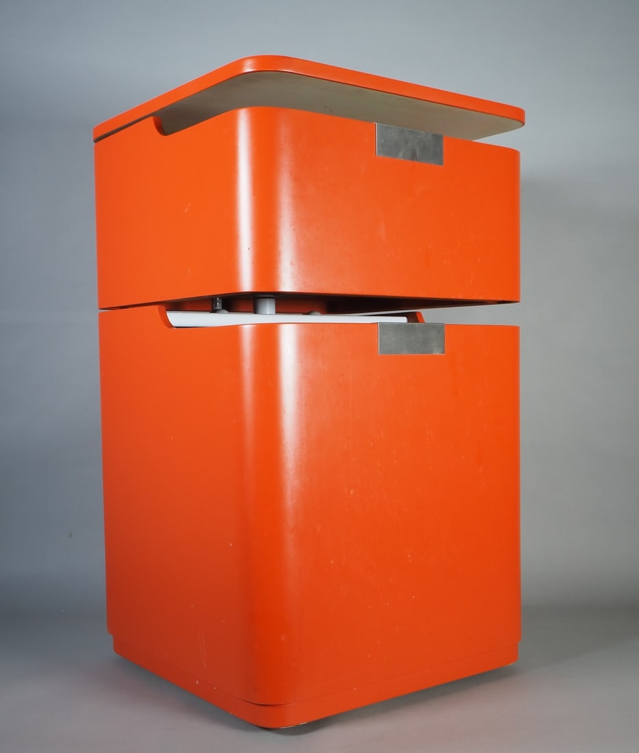 Space Age mobile pedestal, 1960s/70s: Space Age mobile pedestal, 1960s/70sMade of wood, painted orange, with four castors. Square shape with rounded corners and two compartments. Cover and top compartment can be swung open. Dimensions: He