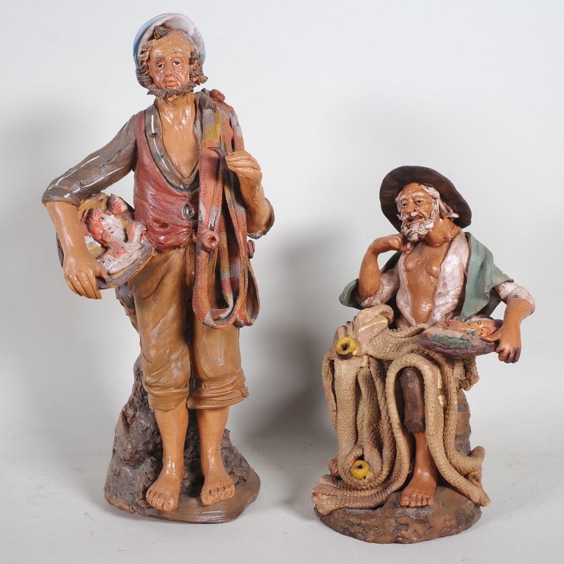 Pair of handmade clay figures depicting fishermen, mid-20th century. (1 of 2)