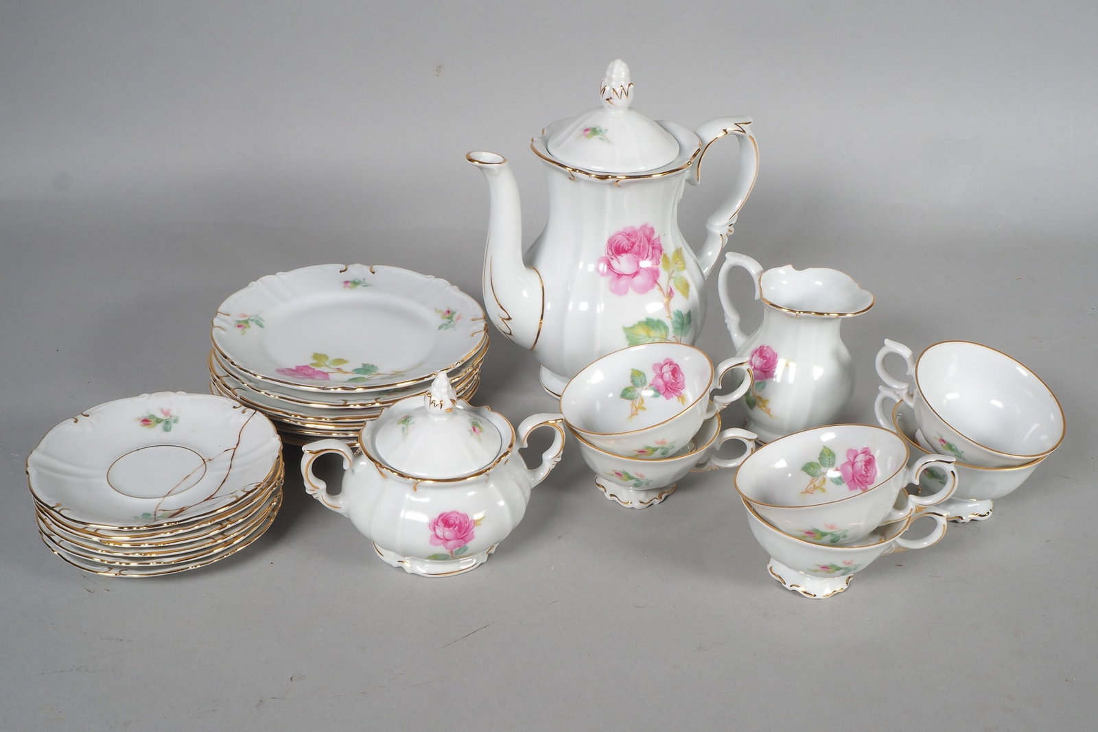 Altenburg Saxony, mocha service for 6 persons, probably early 20th century.: Altenburg Saxony, mocha service for 6 persons, probably early 20th century.Made of white porcelain, polychrome hand-painted with rose decoration and gold staffage. Comprising: a mocha pot, a cream jug