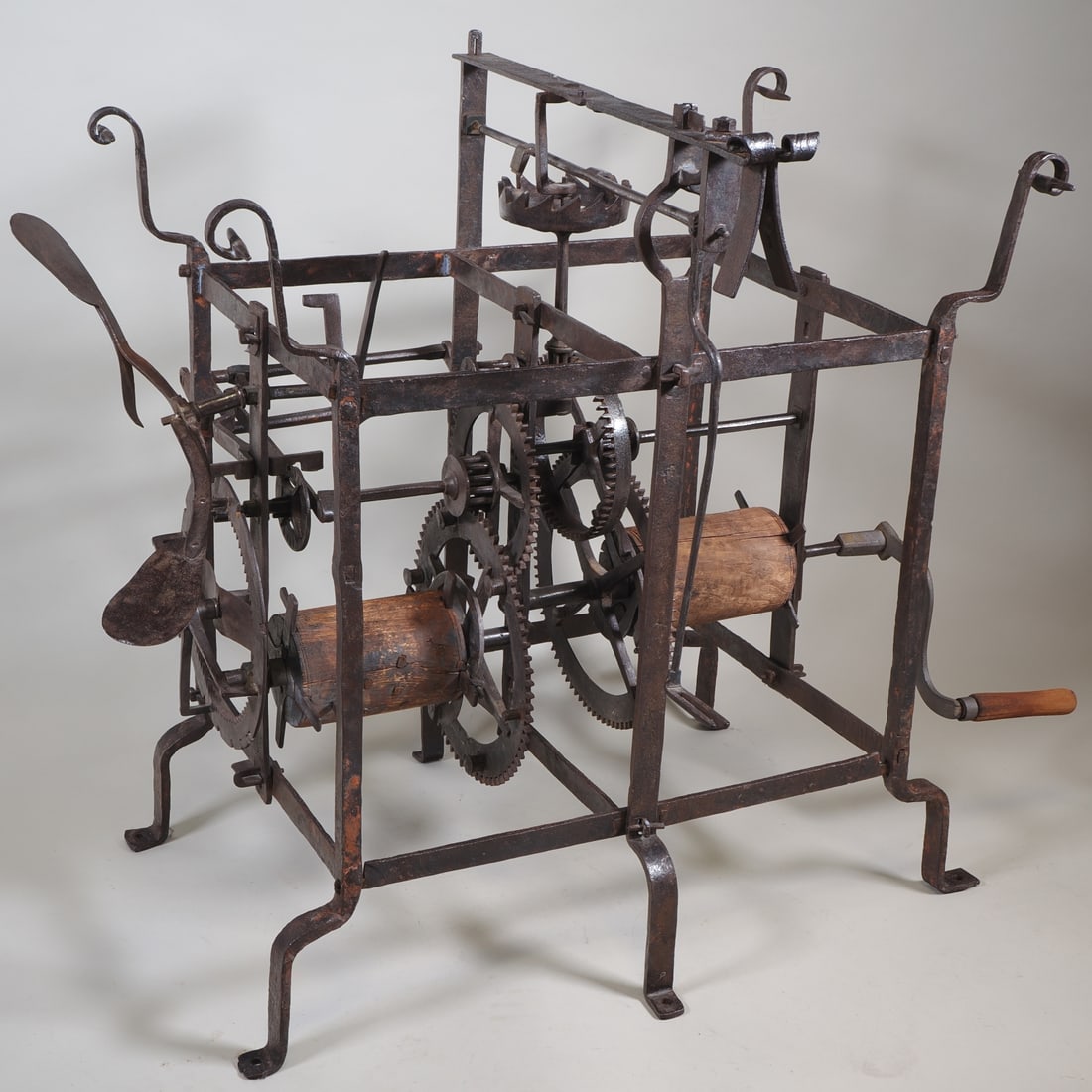 Baroque tower clock, 18th century.: Baroque tower clock, 18th century.Large movement of a Baroque tower clock, circa 1700. Forged iron, two wooden winding drums, detachable construction with iron pins. With manual winding crank. H. 80