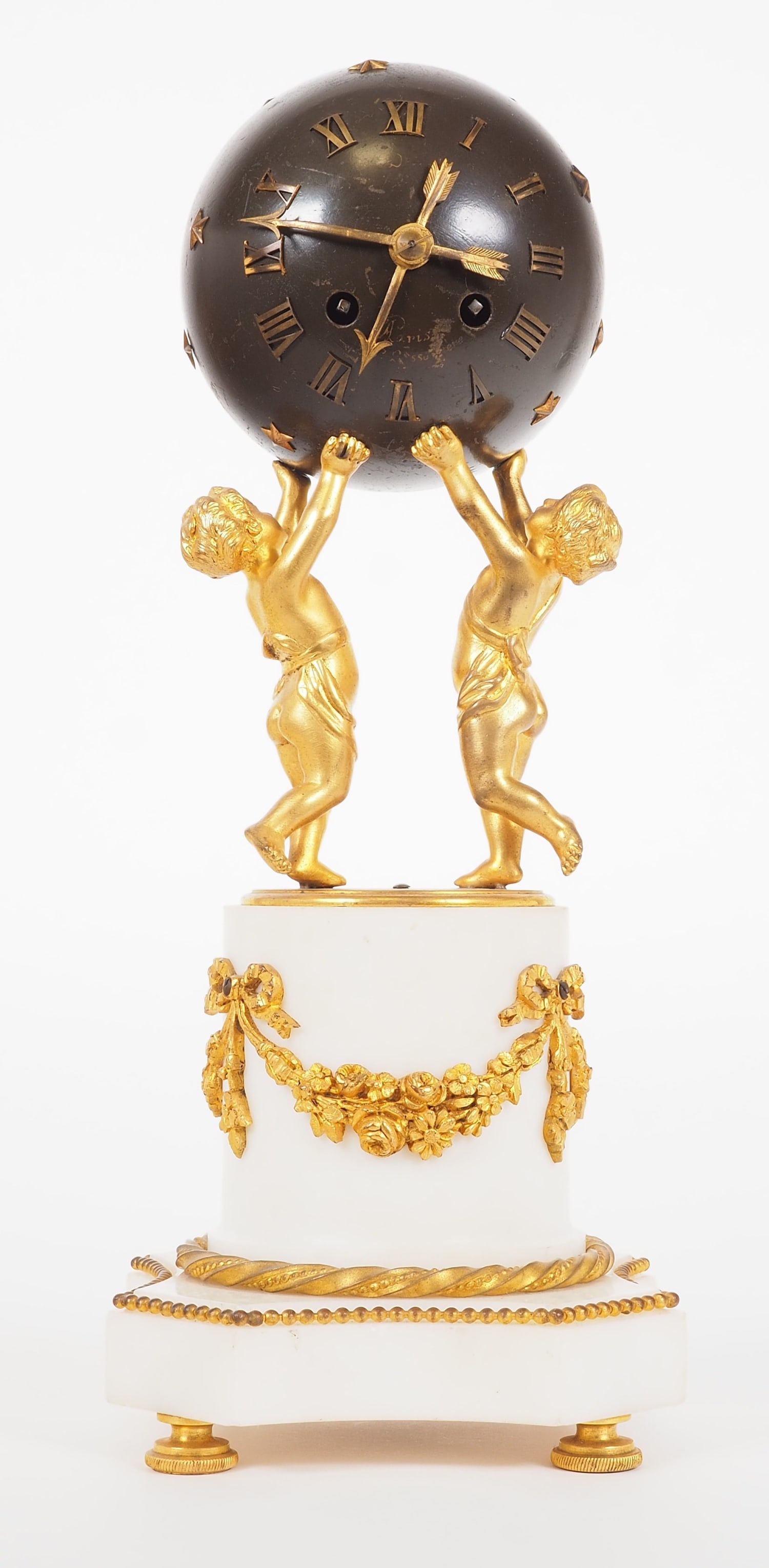 Decorative figurine clock, around 1860: Decorative figurine clock, around 1860Designed and built in the classicist style, with a heavy white marble stand, decorated with fire-gilt bronze ornaments. Standing boy figures holding the