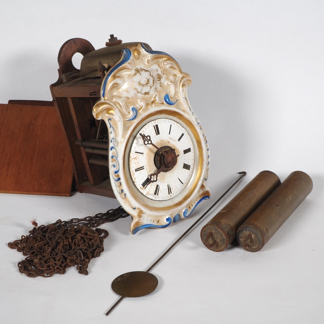 Jockel, Black Forest, c. 1880: Jockel, Black Forest, c. 1880Rare miniature porcelain shield clock in a teardrop shape with slightly raised floral motifs, painted in colour and glazed; slightly domed enamel dial with black Roman