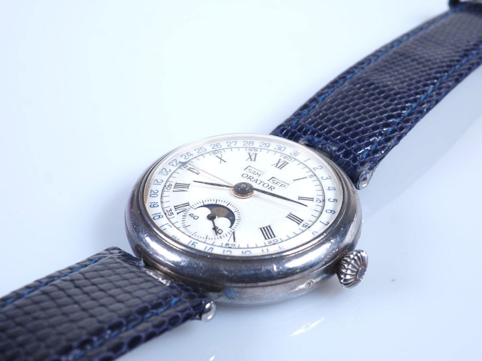 ORATOR wristwatch with moon phase and full calendar, silver case: ORATOR wristwatch with moon phase and full calendar, silver caseVintage "ORATOR" wristwatch in 925 silver case (stamped). White enamel dial with black Roman and Arabic numerals, full calendar, and moo