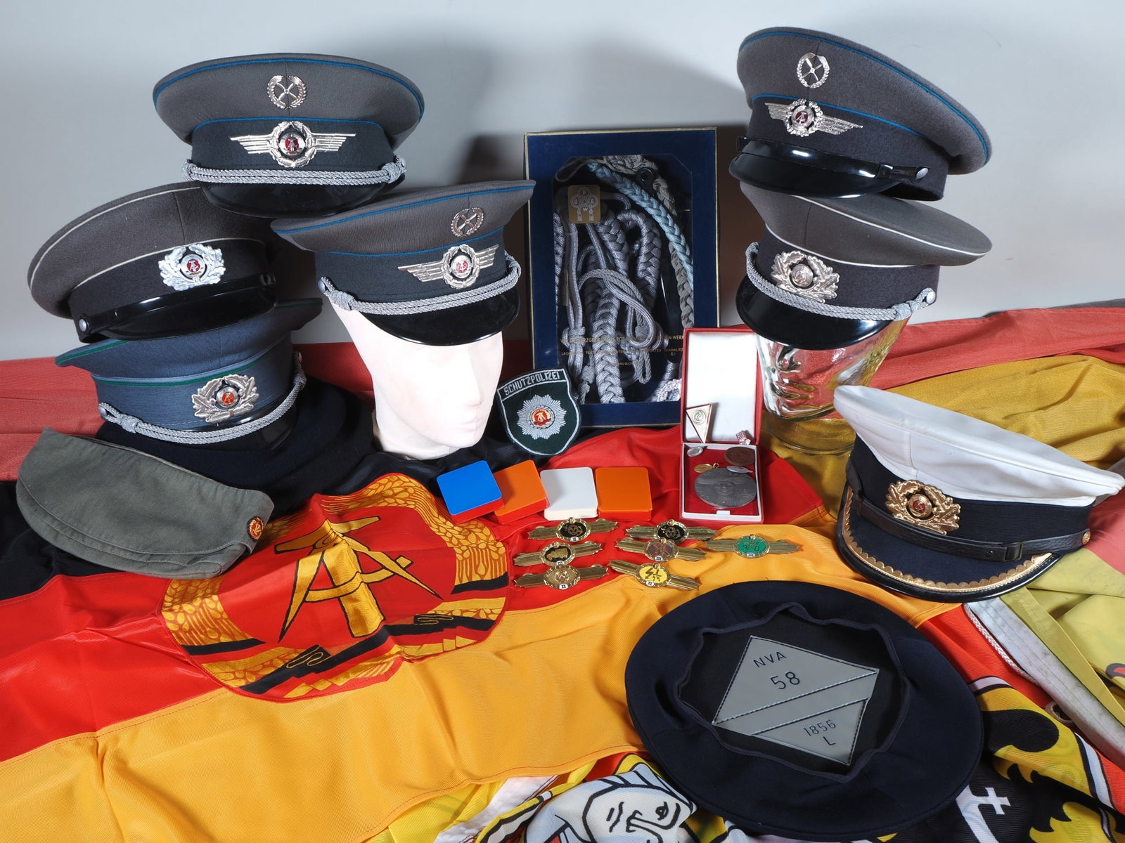 Collection of GDR peaked caps and miscellaneous items, 1980s (1 of 3)
