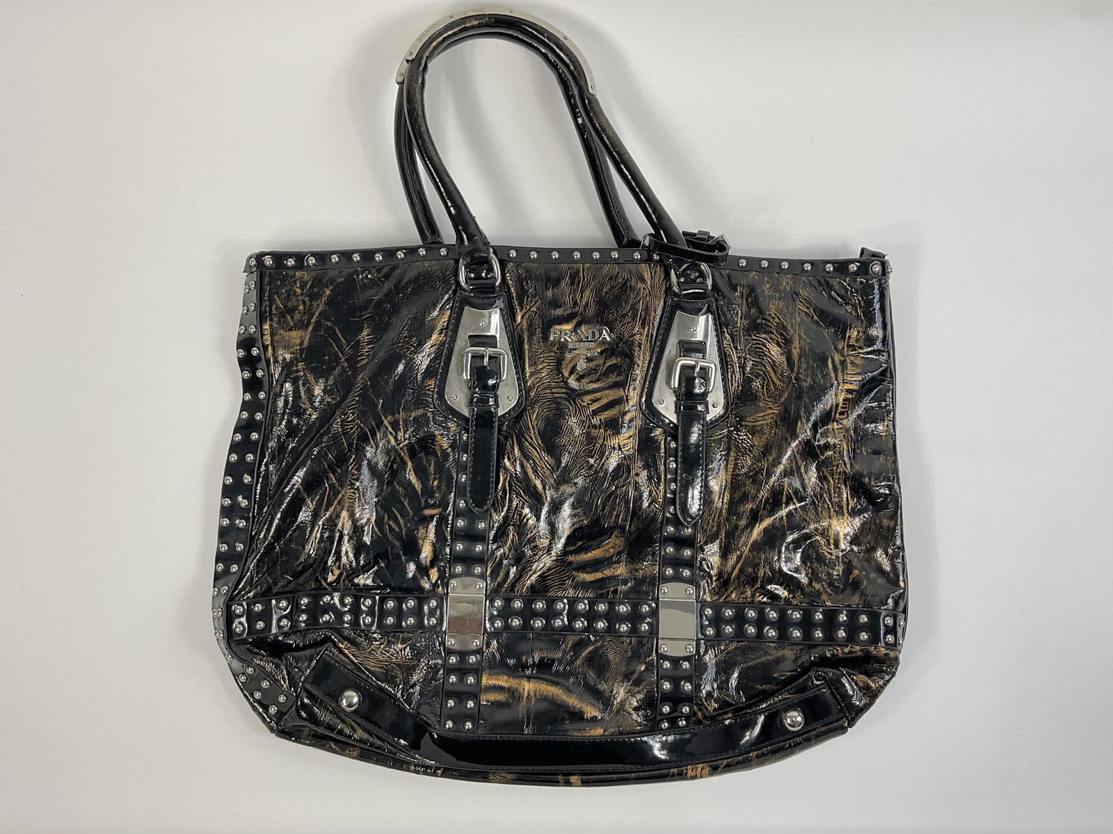 Prada Studded Patent Leather Tote: Slight wear, Discoloraton, Small Rips, and scratches