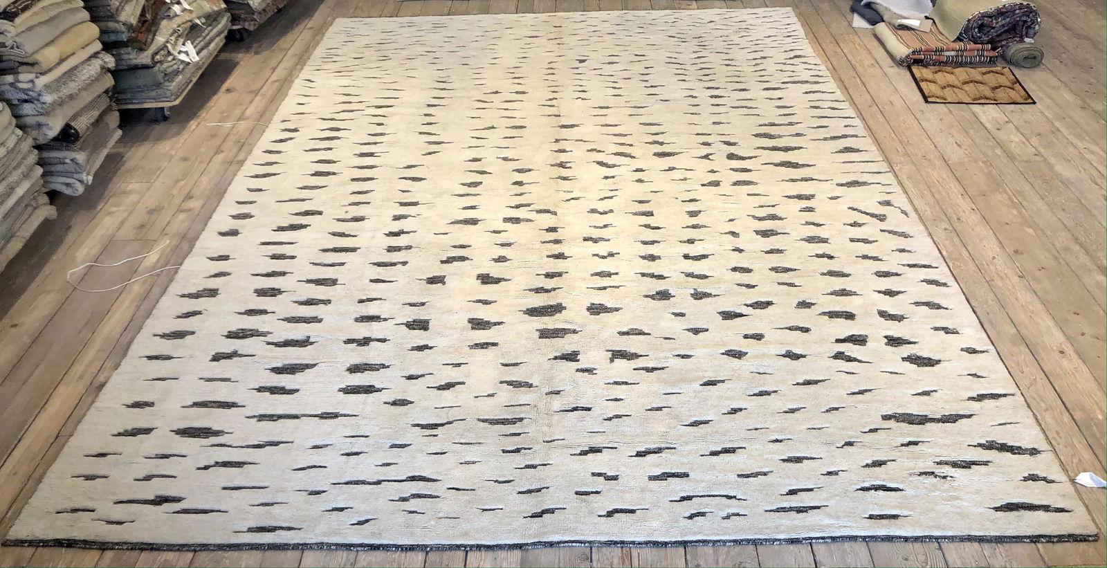 Modern Moroccan Wool 12'0'' x 18'0'' Rug: Hand knotted modern Moroccan ivory grey colored 12'0'' x 18'0'' wool rug made in India. Water mark spots and discoloration present. Note: All items in this auction are as-is.