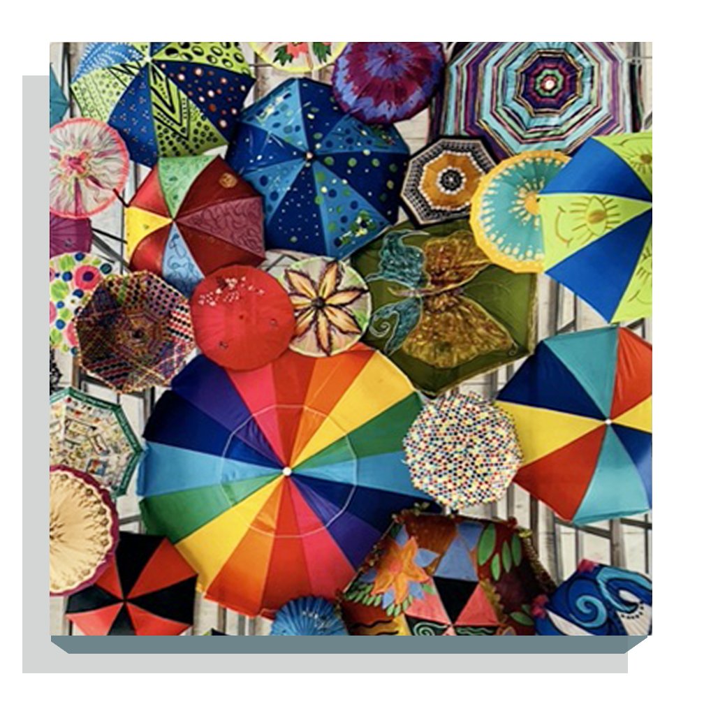 Hunter Stephens / Parasol Kaleidoscope: Photograph. A canopy of vibrant umbrellas and parasols transforms a warehouse ceiling.