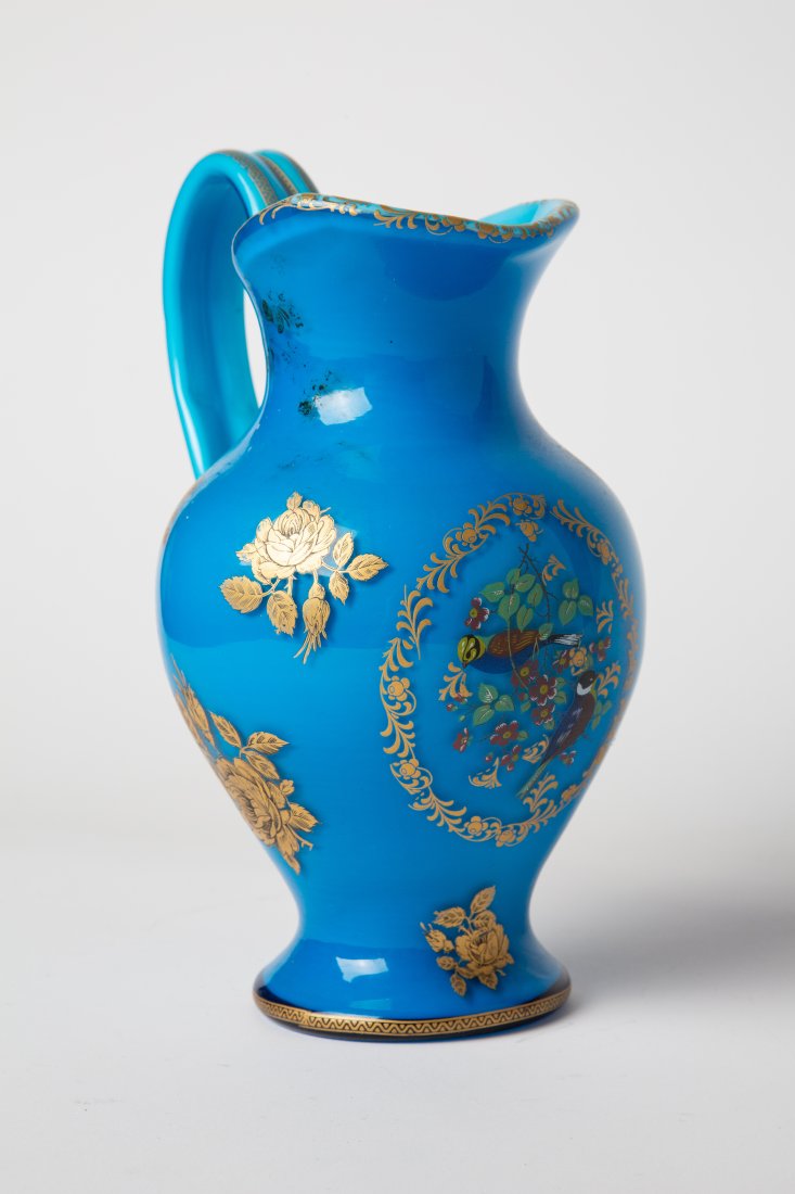 CZECH Bohemian Turquoise Art glass Gold Gilt Pitcher: Czech Turquoise Art glass pitcher with hand painted floral gold gilt designs. H: 9.25 in ; L:6.5in : D: 5.5 in