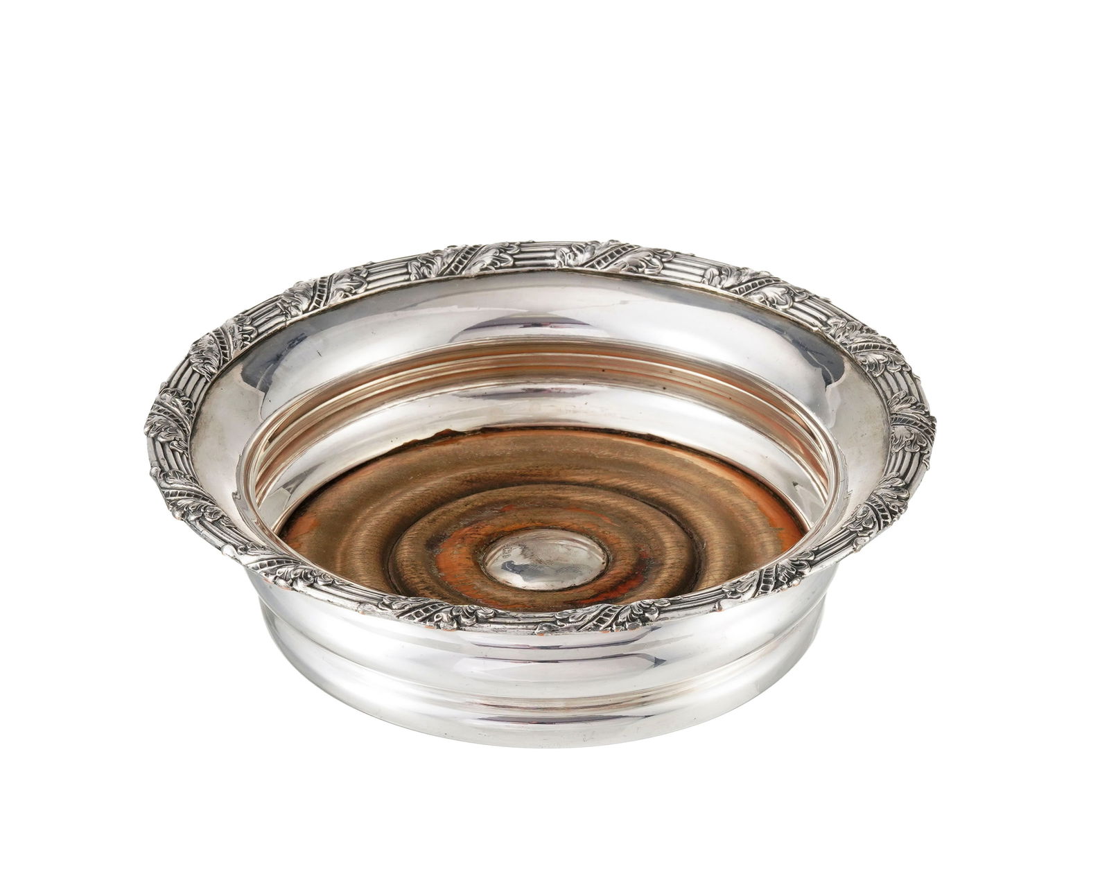 Dessous de bouteille en métal argenté et argent anglais, à décor de feuillage, d: Dessous de bouteille en métal argenté et argent anglais, à décor de feuillage, diam. 18 cm Provenance: Château de Bellerive, Collonges-Bellerive, Genève 