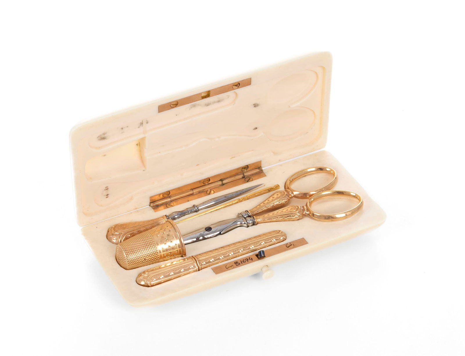 Nécessaire à coudre en or rose 750, France XIXe s., comprenant un dé à coudre, u: Nécessaire à coudre en or rose 750, France XIXe s., comprenant un dé à coudre, un étui à aiguilles, un pique, un enfile-aiguille, et un ciseau, présenté dans