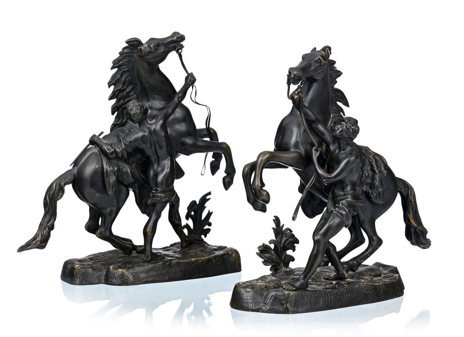 Guillaume Coustou (1677-1746) (d'après), Les chevaux de Marly, 2 épreuves en bronze à: Guillaume Coustou (1677-1746) (d'après), Les chevaux de Marly, 2 épreuves en bronze à patine brun-vert, signés dans la masse sur les terrasses, h. 27,5 et 28,5 cm