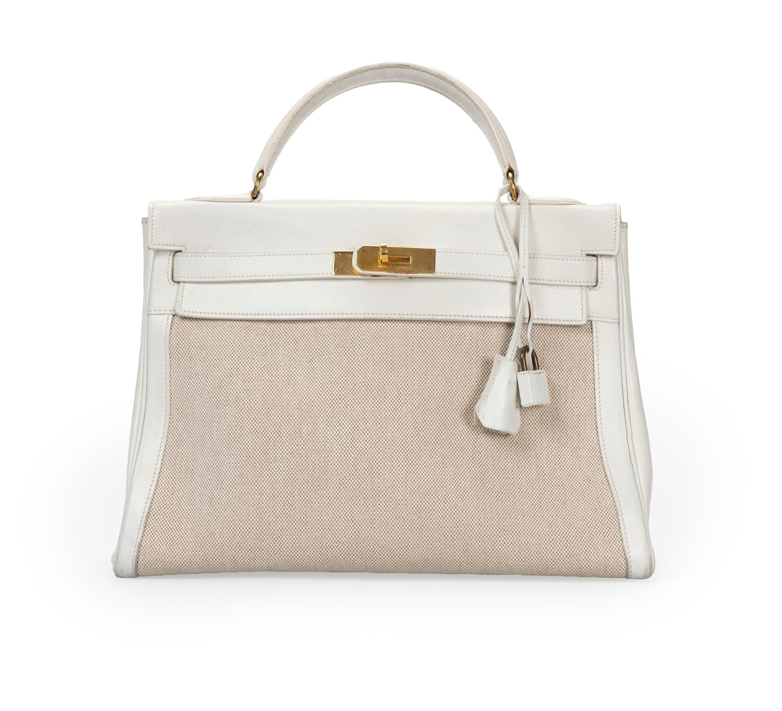 Hermès, sac Kelly 32 Retourné en cuir lisse blanc craie et toile H beige, année 1985,: Hermès, sac Kelly 32 Retourné en cuir lisse blanc craie et toile H beige, année 1985, tirette et clochette avec 2 clefs et cadenas, housse, 23x32 cm ConditionMoyen état de