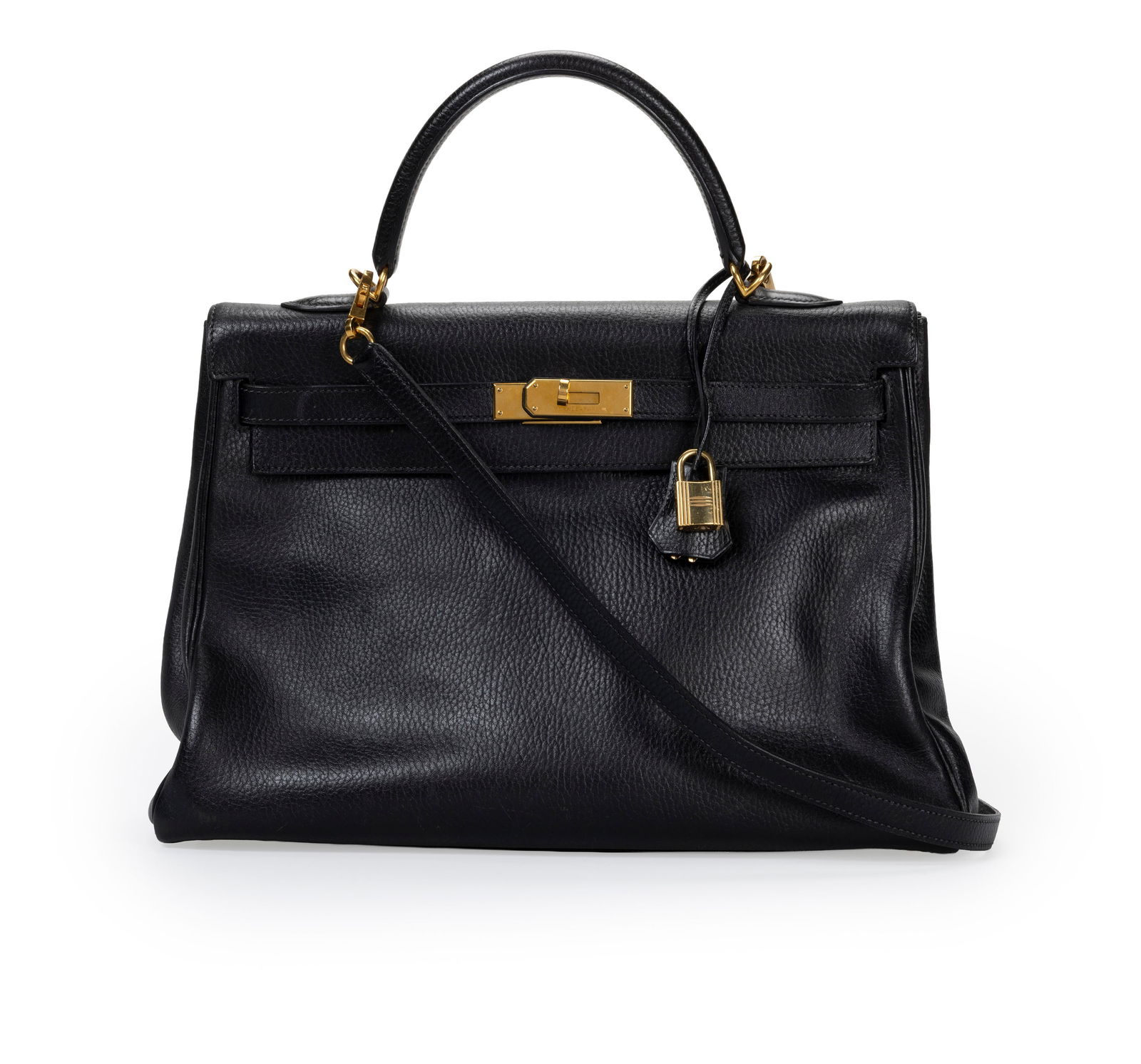 Hermès, sac Kelly 35 Retourné en cuir Ardennes noir, année 2000, bouclerie plaqué: Hermès, sac Kelly 35 Retourné en cuir Ardennes noir, année 2000, bouclerie plaquée or, tirette et clochette avec deux clefs et cadenas, bandoulière. housse, 25x35