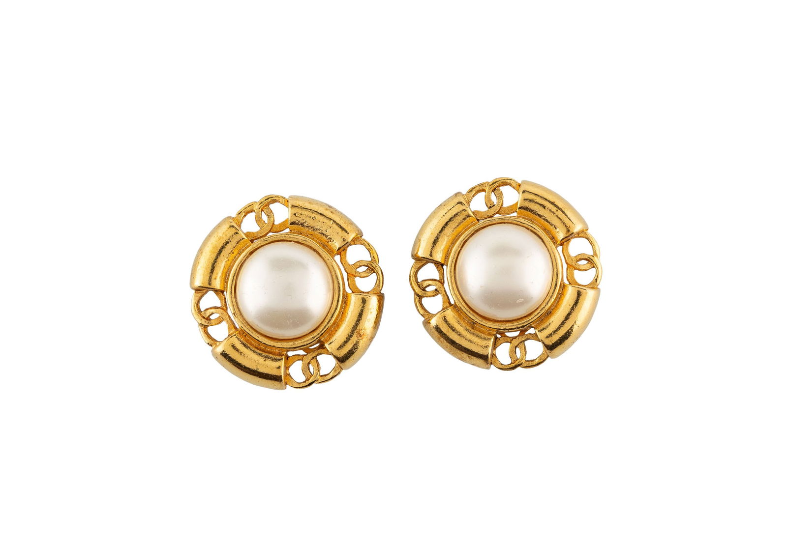 Chanel, paire de clips d'oreilles en cabochon de simili perles monté dans un quadri feuille en : Chanel, paire de clips d'oreilles en cabochon de simili perles monté dans un quadri feuille en métal doré lié par le monogram CC entrelacé, boîte, h. 3 cm ConditionUne