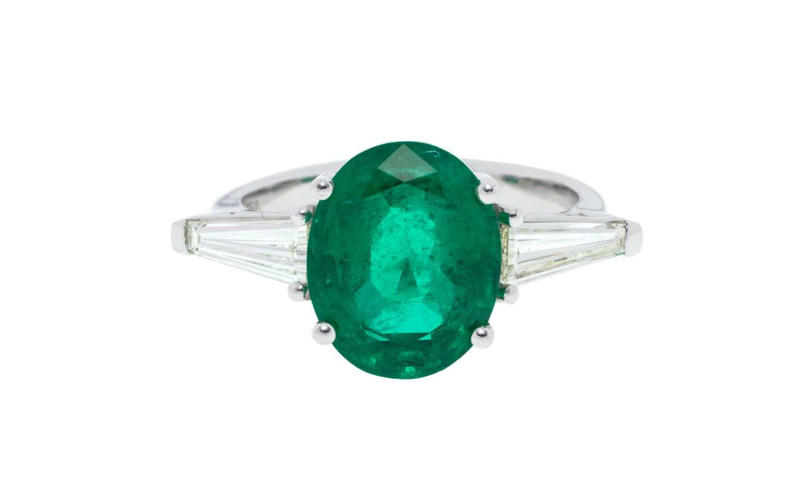 Bague or gris 750 sertie d'une émeraude ovale épaulée de deux diamants taille trap: Bague or gris 750 sertie d'une émeraude ovale épaulée de deux diamants taille trapèze, doigt 53-13 Condition Monture: Très bon état général. Gemmes: Tr&#