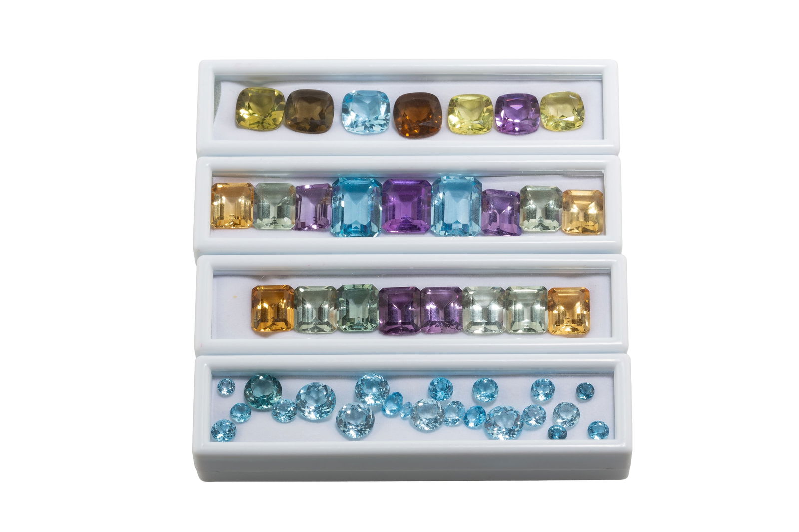 Lot de topazes, quartz vert, améthystes et citrines sur papier de tailles diverses: Lot de topazes, quartz vert, améthystes et citrines sur papier de tailles diverses 