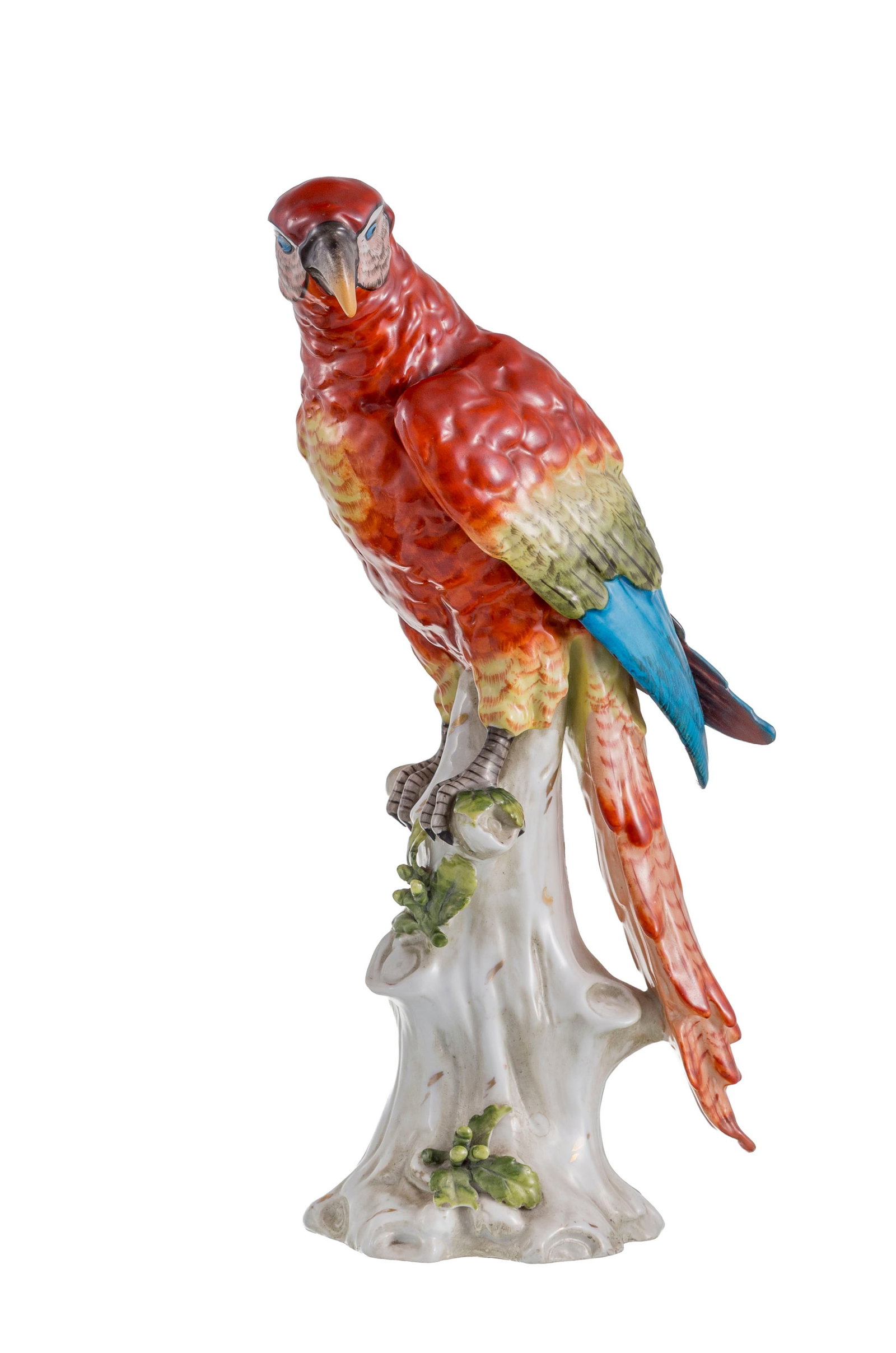 Capodimonte. Perroquet en porcelaine polychrome, XXe s., posant sur un tronc avec feuillage, h. 28,5: Capodimonte. Perroquet en porcelaine polychrome, XXe s., posant sur un tronc avec feuillage, h. 28,5 cm Condition manques au feuillage