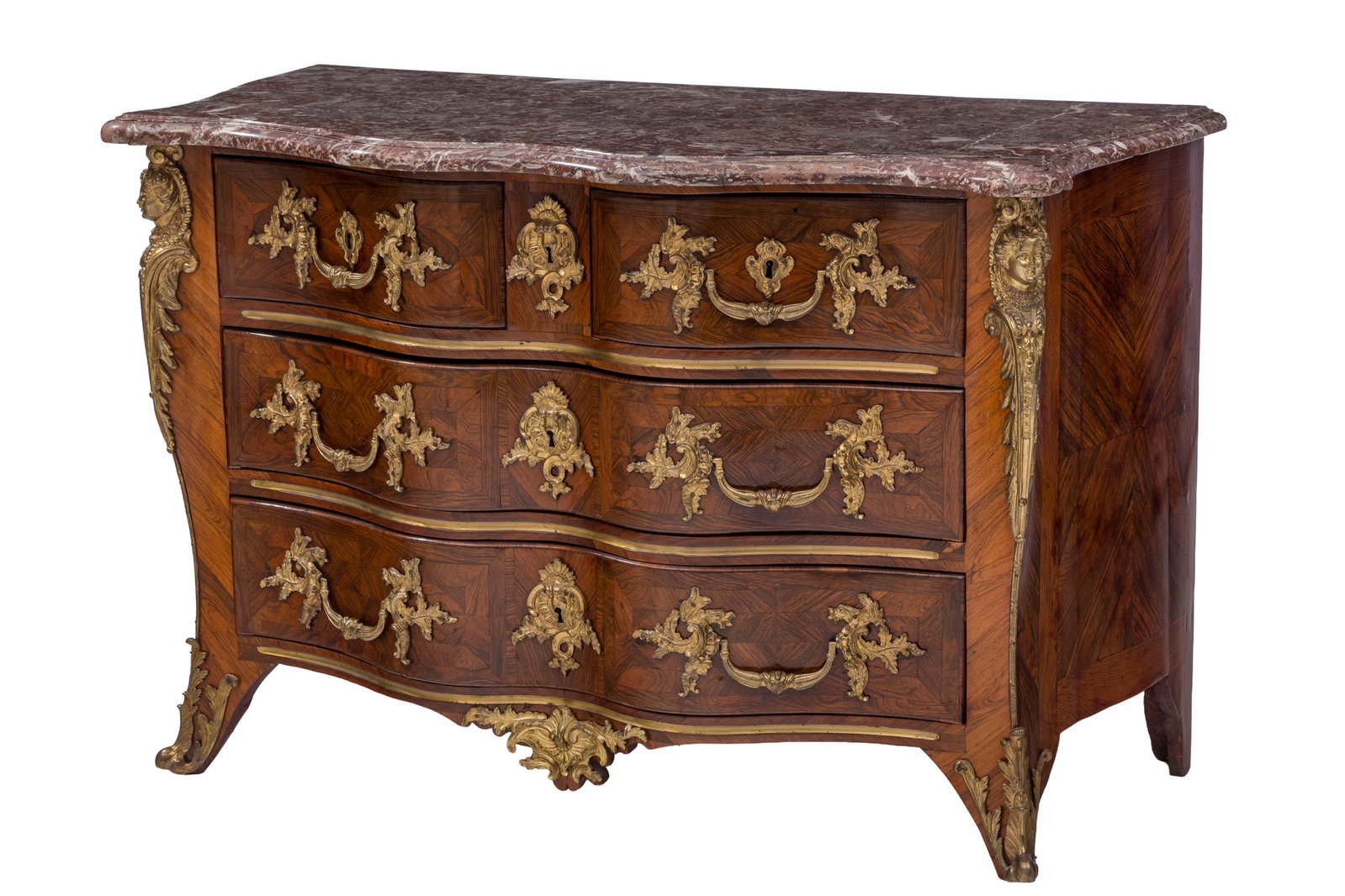 Commode d'époque Régence, en placage de palissandre, façade en arbalète ouvrant : Commode d'époque Régence, en placage de palissandre, façade en arbalète ouvrant par quatre tiroirs sur trois rangs, ornementations en bronze doré, plateau en marbre rance, 85x