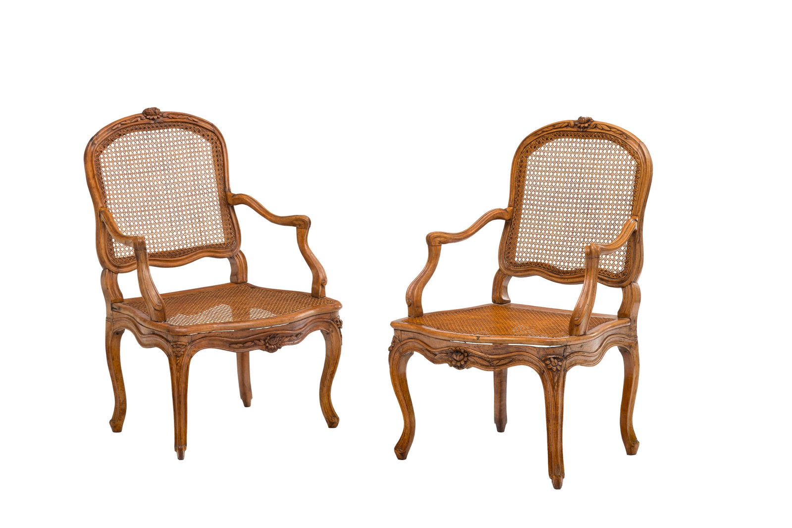 Paire de fauteuils cabriolets d'époque Louis XV, en noyer mouluré et sculpté à d: Paire de fauteuils cabriolets d'époque Louis XV, en noyer mouluré et sculpté à décor de fleurs, pieds galbés, assise et dossier cannés Condition usures et marques