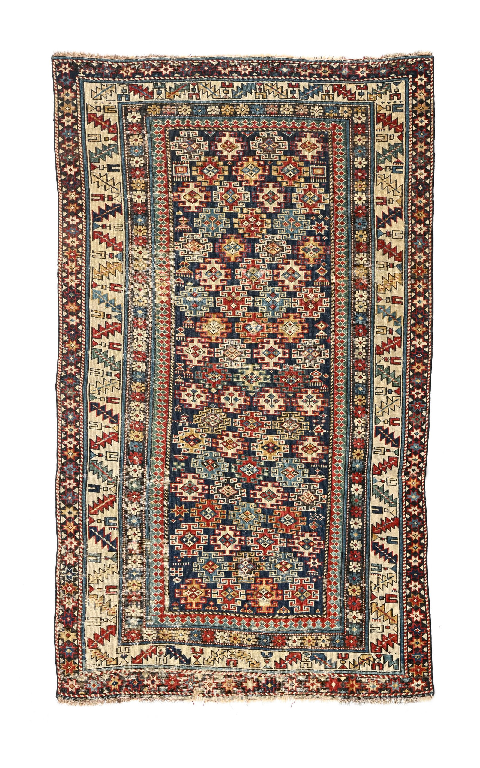 Tapis Shirvan, Caucase, début XXe s., à semis de médaillons à crochets polychrom: Tapis Shirvan, Caucase, début XXe s., à semis de médaillons à crochets polychromes sur fond bleu nuit, bordure beige ornée d'une frise de verres et de feuilles stylisés,
