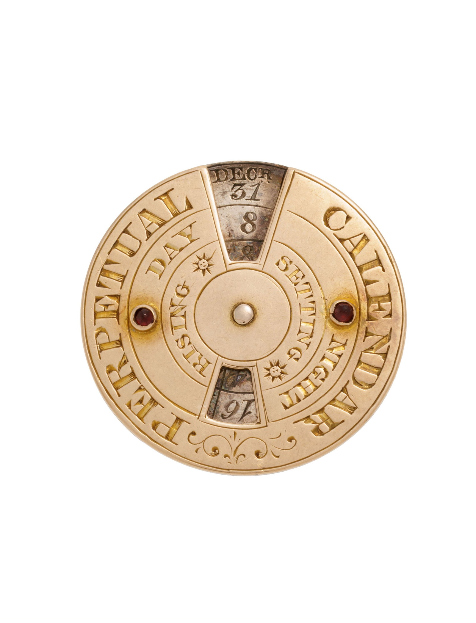 Calendrier perpétuel manuel en or et argent serti de cabochons de grenat, début XIXe s., d: Calendrier perpétuel manuel en or et argent serti de cabochons de grenat, début XIXe s., dim. 2.2 cm, 4g Condition Manque un cabochon de grenat. Le disque ne tourne pas. Présence de