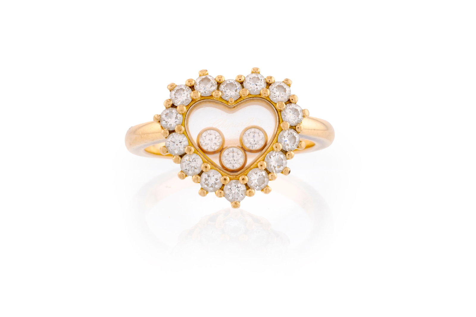 Chopard, Happy Diamonds, bague cœur or 750 sertie de diamants taille brillant dont trois mobile: Chopard, Happy Diamonds, bague cœur or 750 sertie de diamants taille brillant dont trois mobiles entre deux plaques de verre, signée, numérotée, doigt 51-11, 5g, boîte Conditi