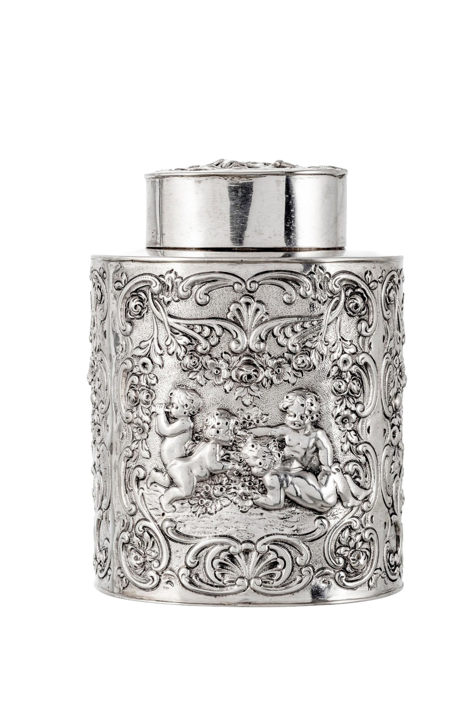 Boîte à thé ovale cylindrique en argent 830, Allemagne, XXe s., à décor en : Boîte à thé ovale cylindrique en argent 830, Allemagne, XXe s., à décor en repoussé de putti, fleurs et feuillage, h. 11,5 cm, 210g