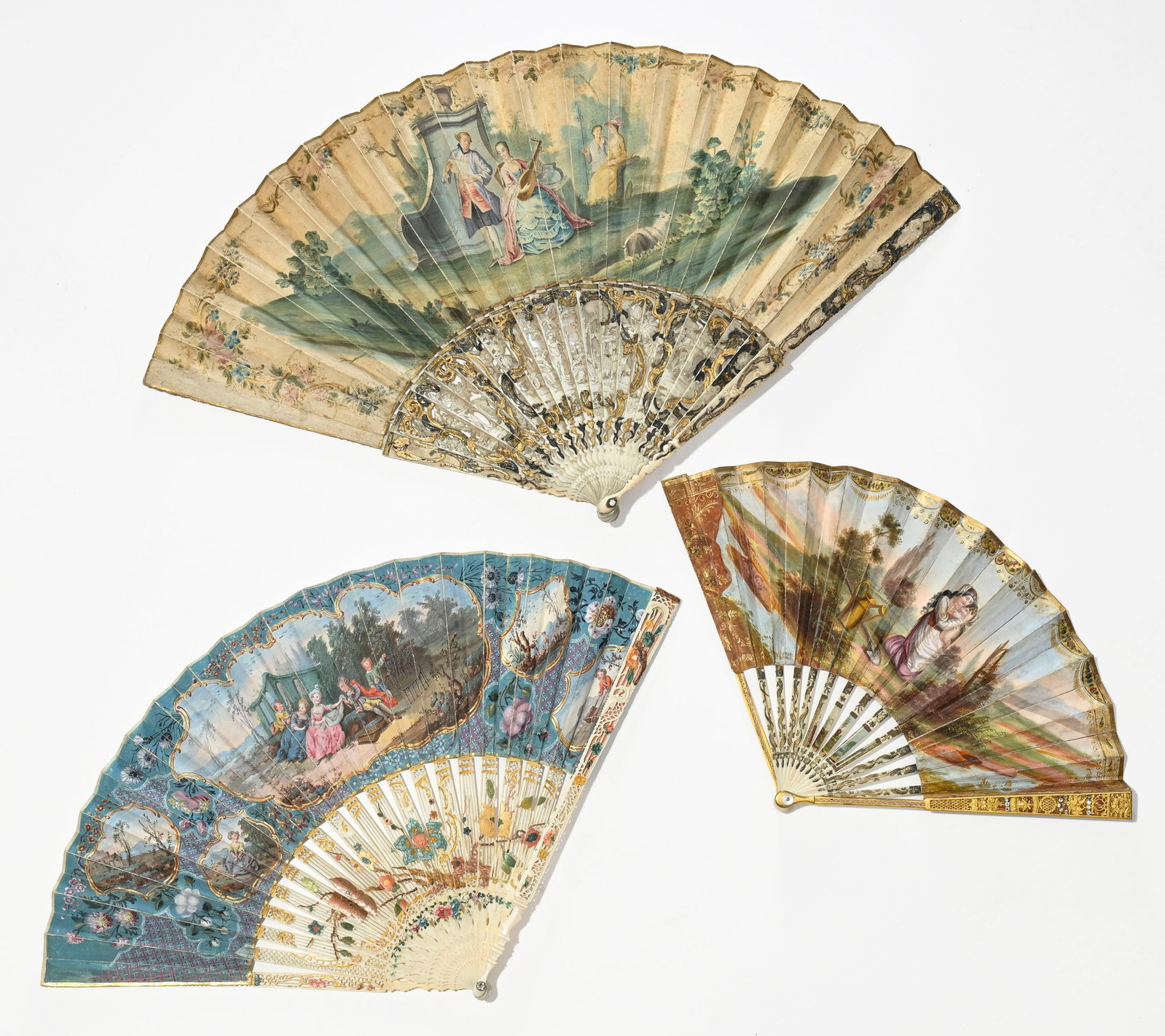 3 éventails à monture en ivoire, France, XVIIIe s., les feuilles peintes de scènes ga: 3 éventails à monture en ivoire, France, XVIIIe s., les feuilles peintes de scènes galantes et pastorales figurant des femmes et des enfants dans des jardins, en cartouches,