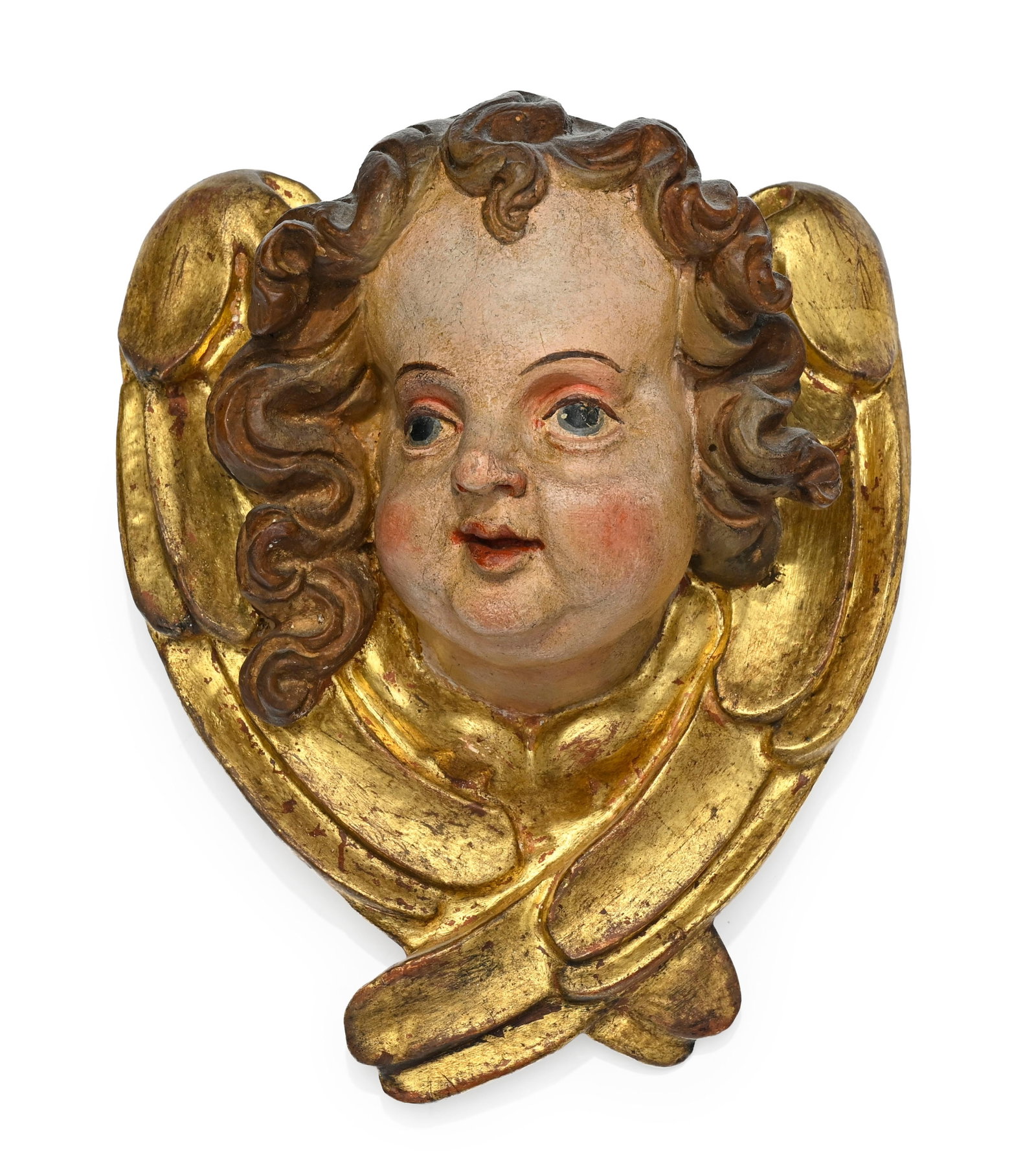 Tête d'angelot en bois polychrome dans un encadrement d'ailes dorés, Sud de L'Allemagne, X: Tête d'angelot en bois polychrome dans un encadrement d'ailes dorés, Sud de L'Allemagne, XVIIIe s., 19,5x16 cm Provenance : Famille Schlote, Göttingen, Basse-Saxe ; collection du Dr