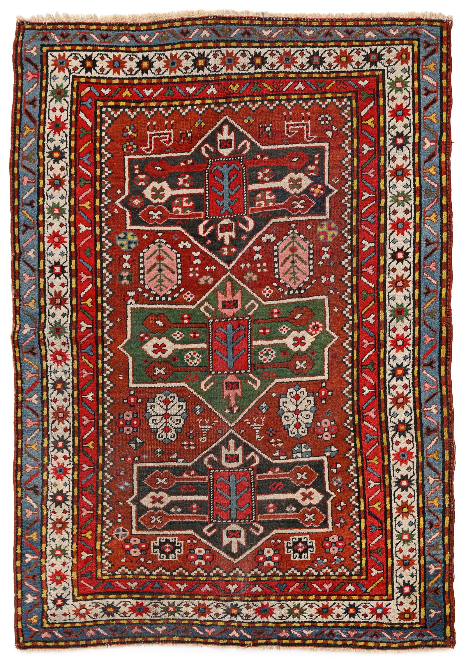 Tapis Kazakh, Caucase, 2ème tiers du XXe s., à trois médaillons centraux polychromes : Tapis Kazakh, Caucase, 2ème tiers du XXe s., à trois médaillons centraux polychromes vert et bleus sur fond rouge parsemé de fleurs et d'animaux stylisés, bordure beige