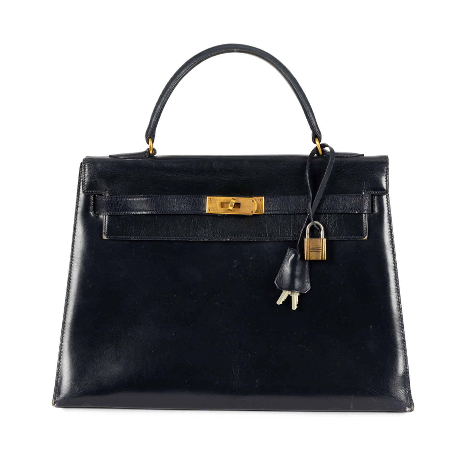 Hermès, sac Kelly 32 Sellier en cuir de box noir, années 1950, probablement 1959, tirette : Hermès, sac Kelly 32 Sellier en cuir de box noir, années 1950, probablement 1959, tirette et clochette avec 2 clefs et cadenas, bijouterie plaquée or, poinçons aux plaques ainsi qu