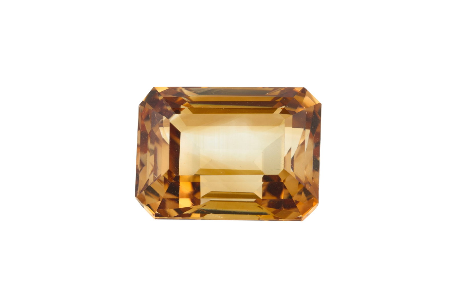 Une topaze rectangulaire à pans coupés couleur jaune-orangé sur papier de 20.53 carat: Une topaze rectangulaire à pans coupés couleur jaune-orangé sur papier de 20.53 carats