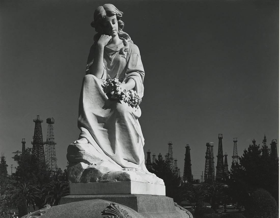 Ansel Adams, Signal Hill, 1939: Ansel Adams, Signal Hill, Long Beach, California - Cemetery Statue and Oil Derricks, 1939. gelatin silver print, 14 1/2 x 18 inches, on a 22 x 26 inch Hi Art mount board. Signed on mount recto in penc