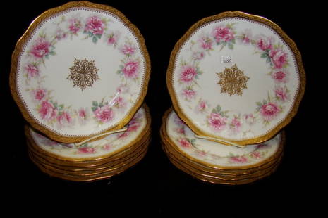 Eleven 9" Haviland plates decorated with pink flowe: flowers and heavy gold rims