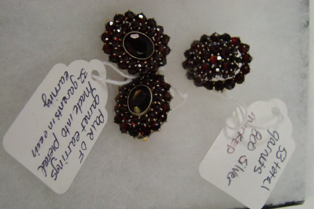 An 800 silver ring with 53 garnets and a pair of e: of earrings made into pierced with 32 garnets in each earring
