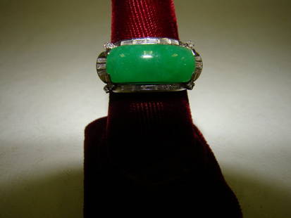 A platinum and jade ring with 16 baguette diamonds: and 8 small diamonds, size 8 1/2