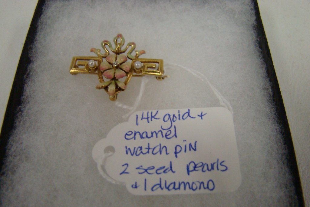 A 14kt yellow gold enameled watch pin with 2 seed : 2 seed pearls and 1 diamond