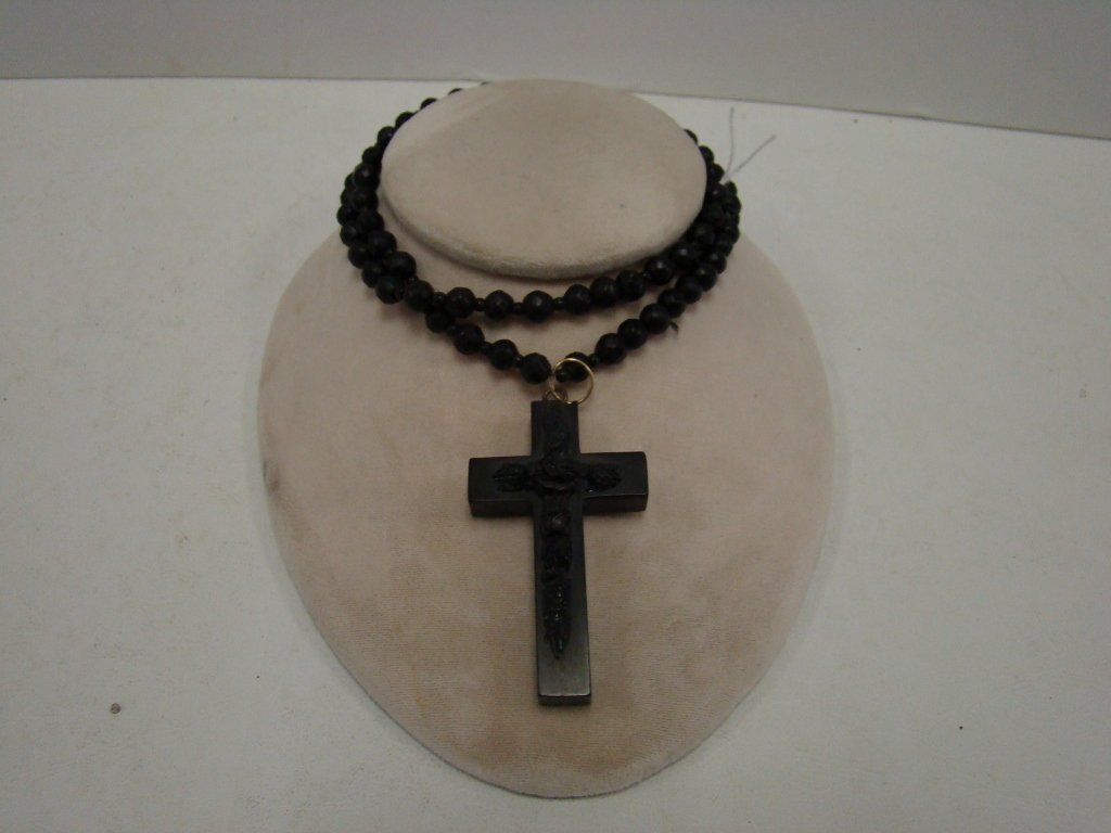 A bog oak necklace with early plastic cross