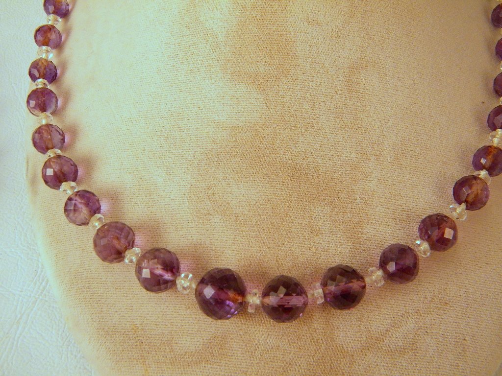 A graduated faceted-bead amethyst necklace with 14: 14kt gold clasp and a double-strand faceted-bead amethyst bracelet with unmarked gold clasp