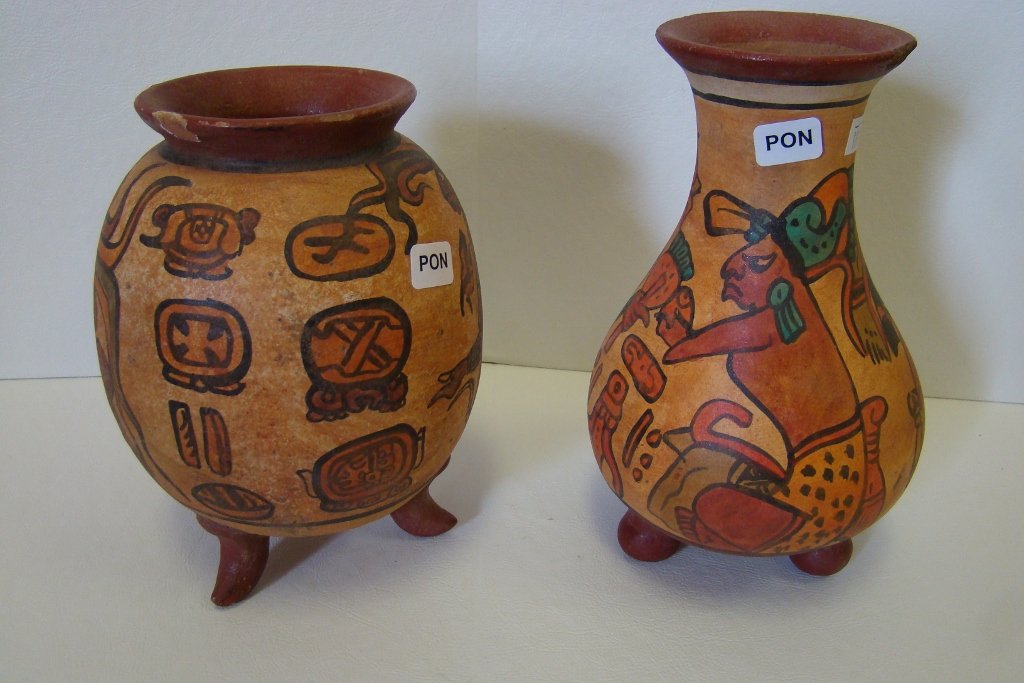 Two Mayan Indian-style tripod vessels with hand mu: with hand mural-style decoration with imperfections on both lips; both are older quality reproduction pieces