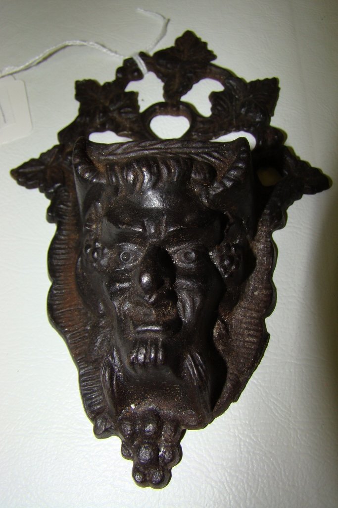 An iron wall match holder, 6" long with devil face: 6" long with devil face