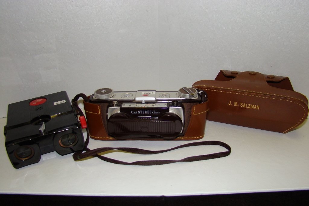 An Kodak stereo camera with case, plus a Realisti: a Realistic stereoscope viewer
