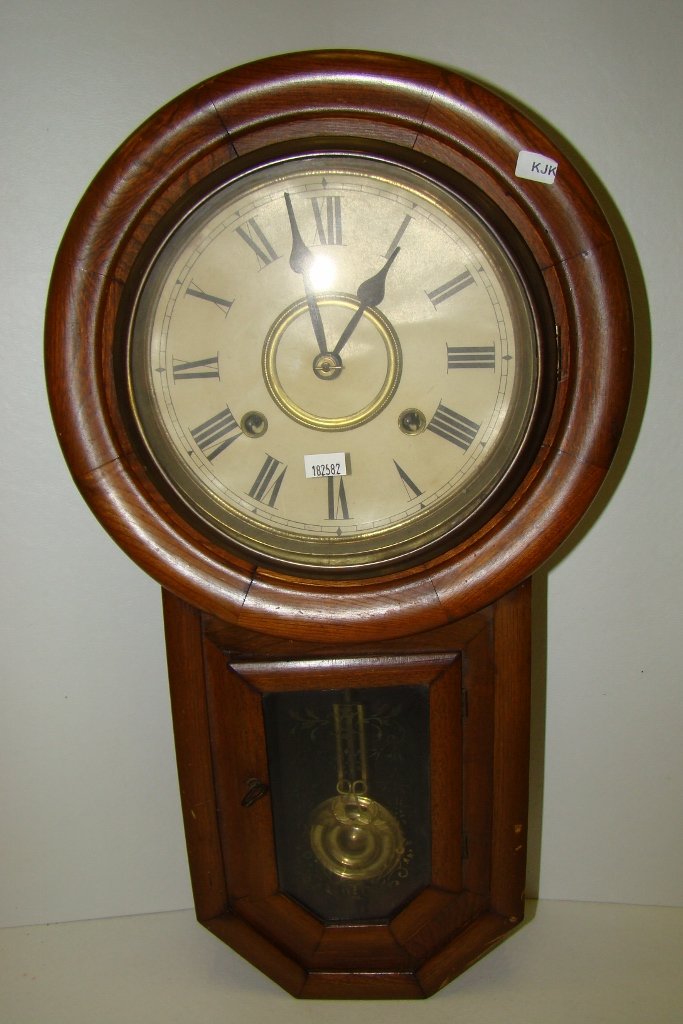 Long drop walnut striking wall clock with round fa: round face