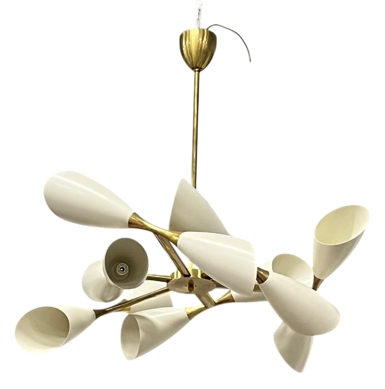 Mid-century style chandelier, Italy limited production.: Italian ivory lacquer and solid brass chandelier with 6 arms each containing an ivory cone on each end. 12 sockets. Not UL Certified. May need rewired
