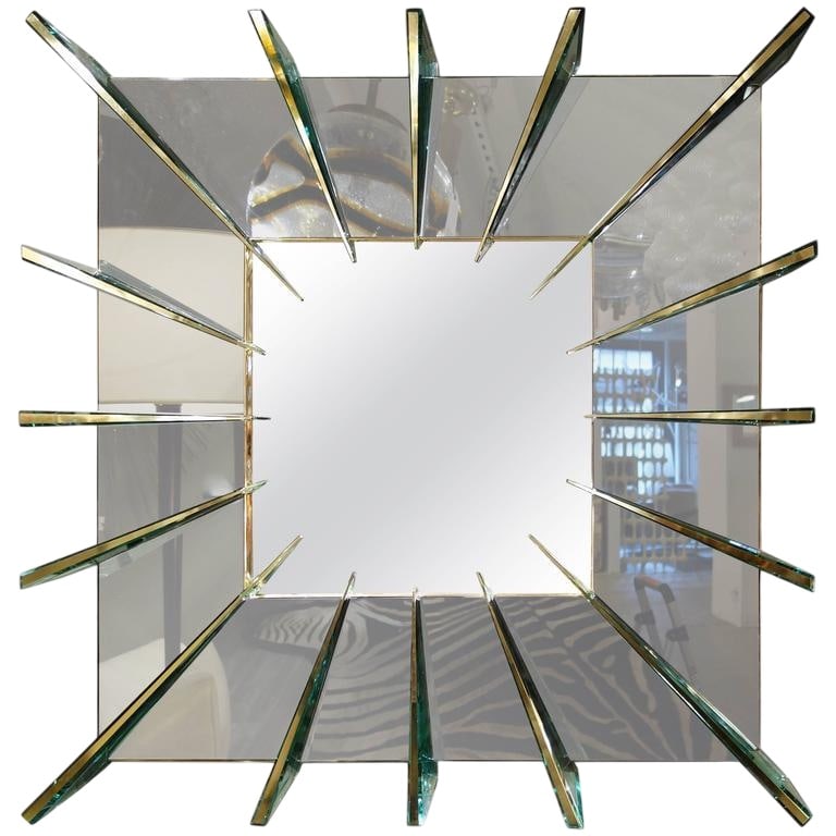 Italian unique glass mirror by Ghiro Studio.: A one of a kind square hand-carved 45" mirror designed and produced by the renowned Italian studio of Michele Ghiro, the wide smoke gray border punctuated by 16 pale green tinted brass faced mirrored