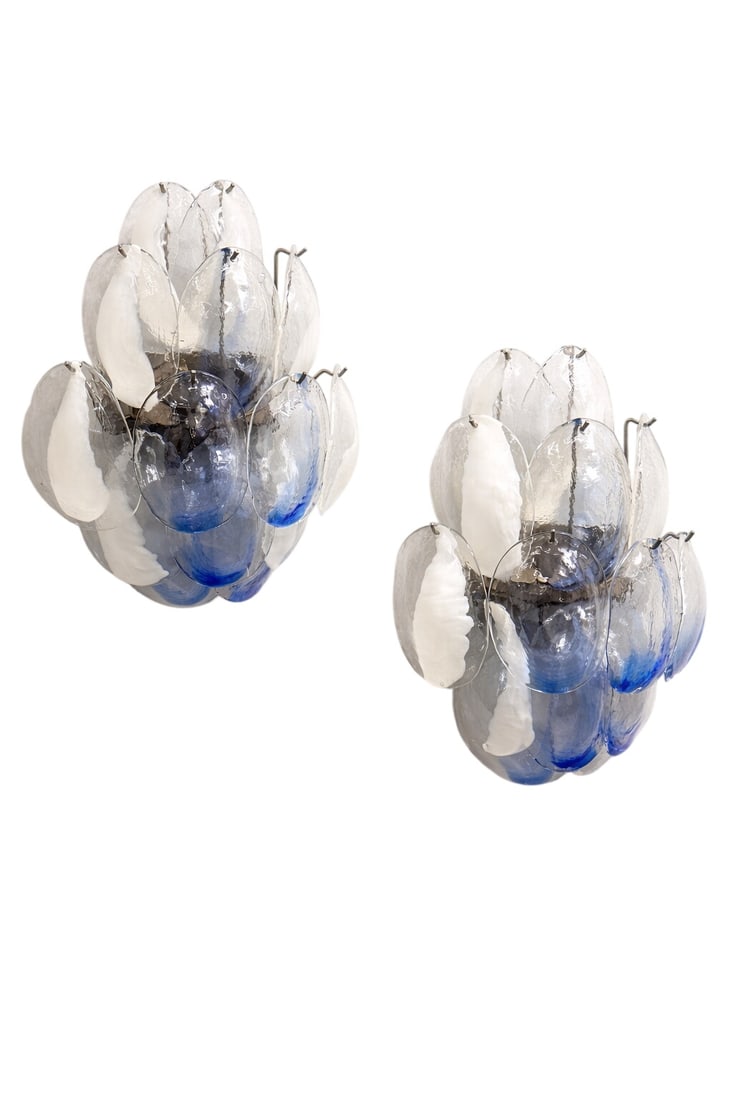 Pair of Murano Sconces: This pair of 1970s Italian wall lights are Murano glass sconces designed by La Murrina.Each light is composed of multiple shell or petal-shaped glass elements. The glass is clear with distinctive blue