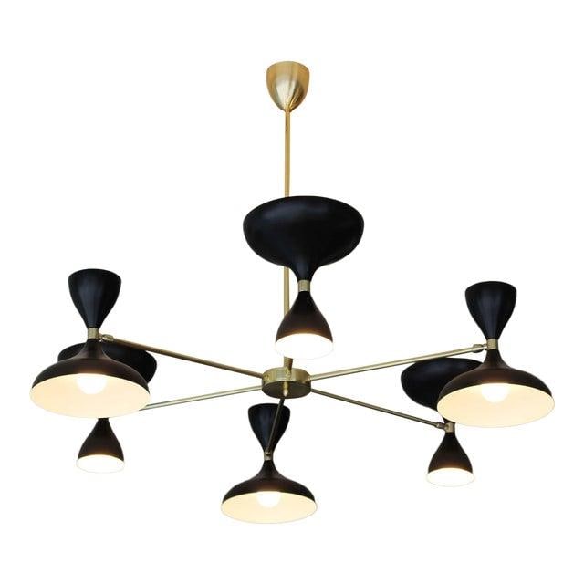6 Arms Brass Chandelier: Sunburst design chandelier, with six brass arms and pivoting powder coated Black Cones with up double sided light sockets. All made in Italy. Also available with half black and half ivory cones.