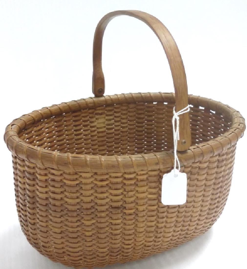 9" long Nantucket basket with paper label "Made by (1 of 4)